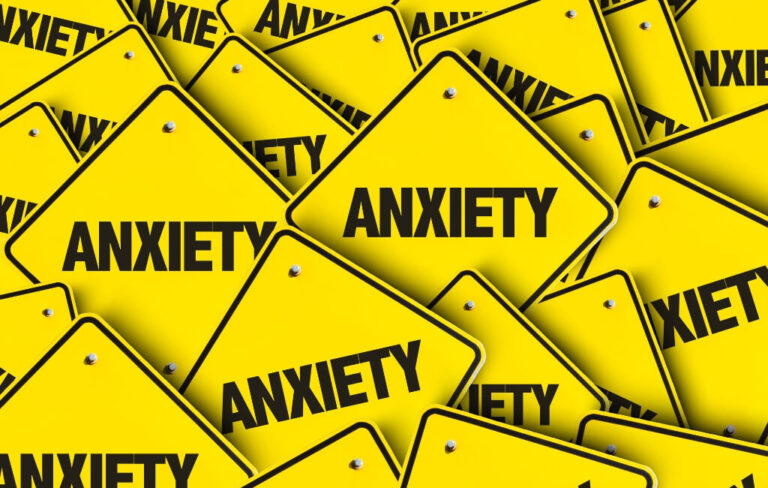 Yellow caution signs with "ANXIETY" text