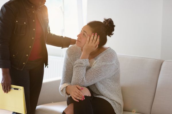 A therapist comforting her client during a counseling session