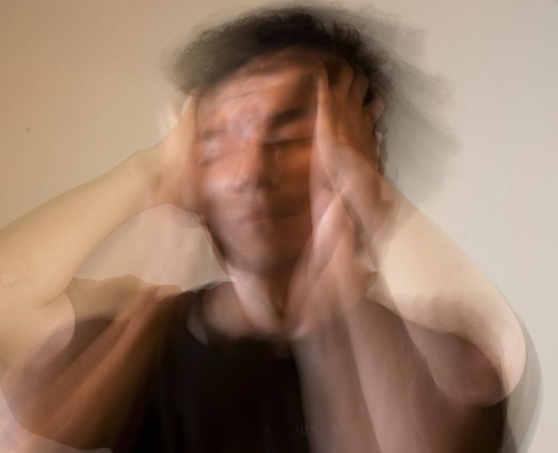 Blurred motion portrait conveying distress, related to trauma experience.